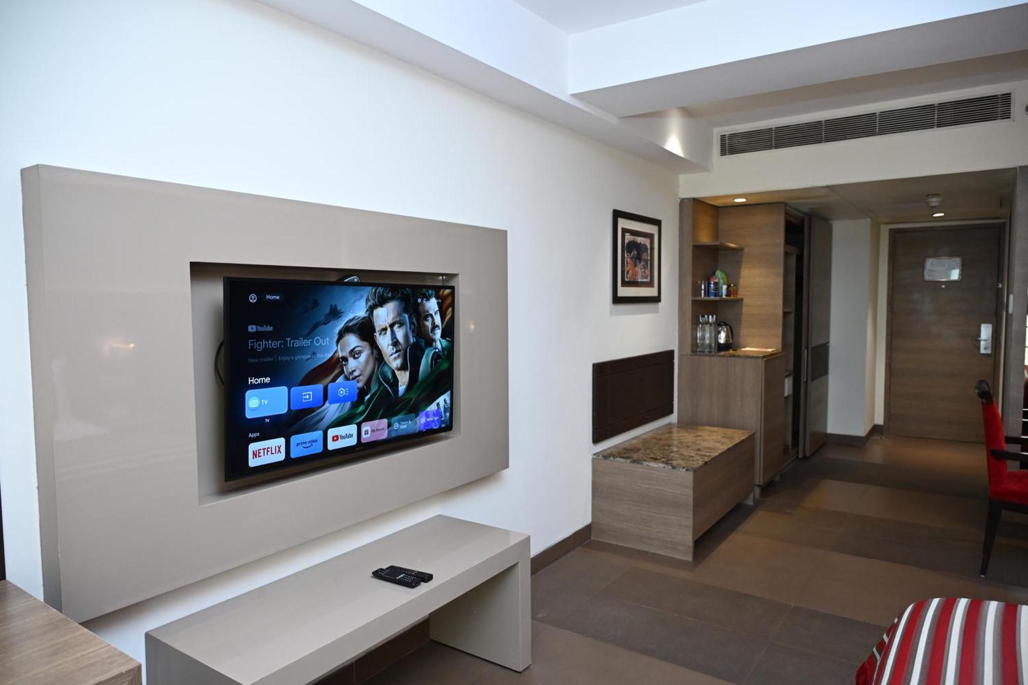 The Lalit New Delhi Hotel Exterior photo A television set in a hotel room